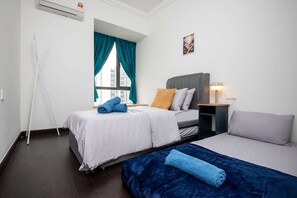 A second bedroom with a TWO single sized bed and a single floor mattress & plush pillows.