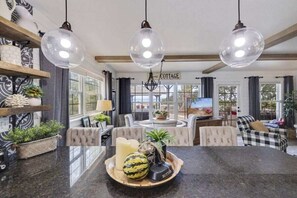 Cozy and functional dining area with a four-seat table and additional stools at the kitchen counter, creating a flexible space for meals and conversation.