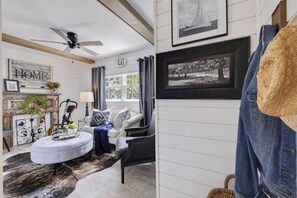 Cozy TV room equipped with gym gear, offering the perfect space to unwind with a show or get in a quick workout, all in one spot.