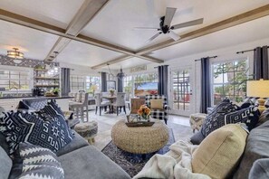 Bright and airy living room that seamlessly connects with the kitchen and dining area, offering plenty of room for you and your family to relax and enjoy together.