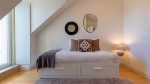 This inviting corner features a comfortable single bed and subtle decor, ideal for relaxation. #SimpleElegance #ComfyCorners