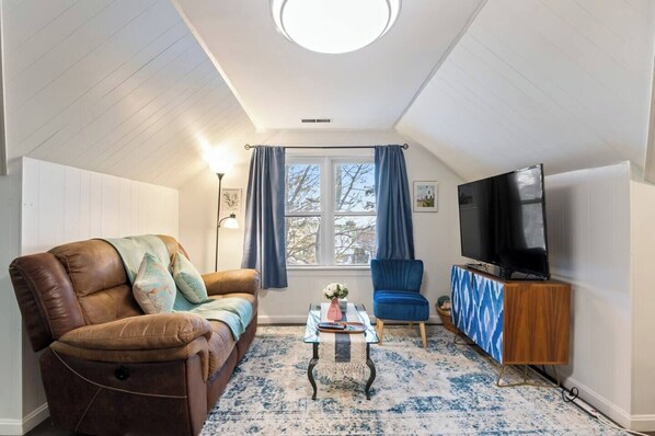 Cozy living room with a plush sofa, plenty of natural light, and a Roku TV.  