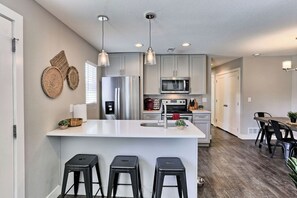 The kitchen countertop has stools for seating.