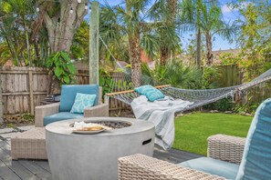 Vibrant outdoor space with fire pit perfect for lounging and enjoying the breeze.