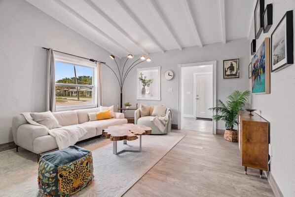 Relaxing living area with comfy seating and a wall-mounted TV.