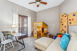 The kids will love the extra room with a climbing wall, playhouse, and desk