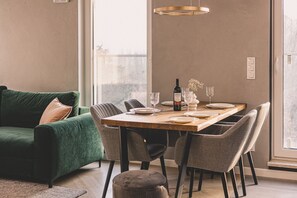 An elegant table in a spacious living room, perfect for a romantic dinner with a glass of wine. The stylish interior and attention to detail make every moment here truly special.