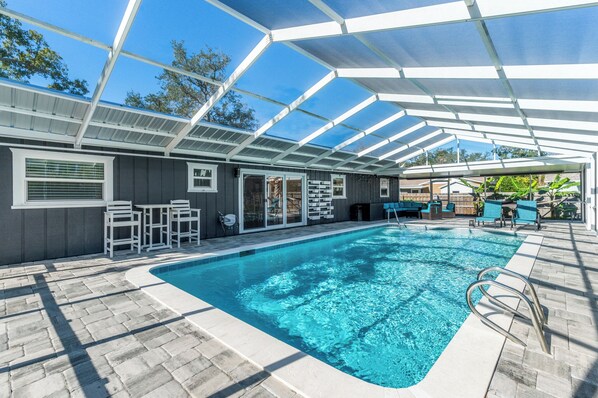 Large pool with plenty of outdoor seating and loungers for your whole family to enjoy!