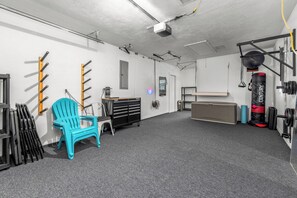 Home gym with the perfect setup for bodyweight exercises, pull ups, resistance bands, punching bag and bike racks! Plenty of space for yoga and meditation!