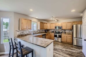 Experience the convenience of a well-stocked kitchen, equipped with modern appliances and tools