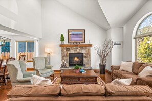 Cozy living room with gas fireplace and cathedral ceilings.
