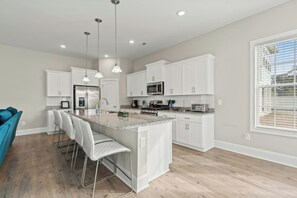 The kitchen island provides additional counter space for serving snacks or meals