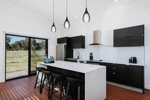 The kitchen comes fully equipped for your holiday catering and is designed around a central island where you can enjoy casual meals in the morning.
