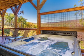 Unwind in a large hot tub with stunning mountain views.
