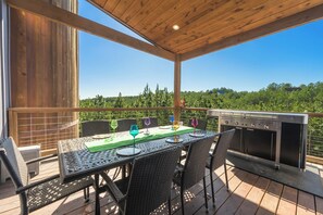 Balconies! The patio is adjacent to the kitchen and comes equipped with a gas grill (pizza oven included), patio table and s'mores trolley to send down anything you need to the campfire.