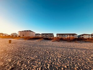 A view from the beach looking inward at the low-rise condo.