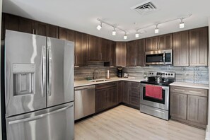 Fully equipped kitchen with fridge, stove, oven, microwave, sink, and all cooking supplies provided for your convenience.