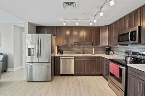 Fully equipped kitchen with fridge, stove, oven, microwave, sink, and all cooking supplies provided for your convenience.