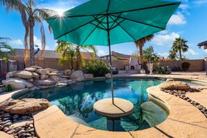 In pool seating and table is the perfect place to sit and sip a refreshing drink