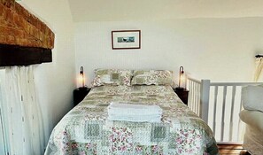 Comfortable double bed, side tables and lamps.