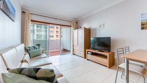 Bright and cozy living area with a plush sofa and access to a private balcony. Perfect for relaxing after a day of exploration! #CozyLiving #HolidayRetreat