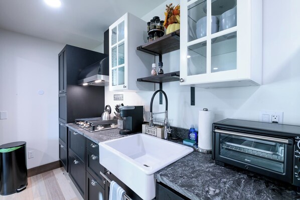 Fully stocked kitchen with all the essentials, microwave & a gas stove.