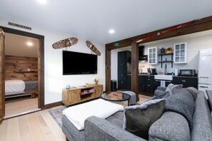 Living Room with 65" 4K TV, Board Games and Books. 