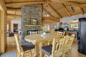 Dining room table for 6 sits next to sliding glass doors that have direct view of Pike's Peak