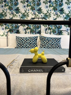 Suite 1: Private entrance with semi-private porch or additional optional entry through hallway, King Anthropologie bed, 50" Smart TV, porcelain tile bath, and option to adjoin with Suite 2. 