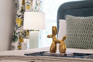 Suite 6: Queen bed, 50" Smart TV, porcelain tile bath with soaking tub, and table with 2 chairs for meals or WFH.