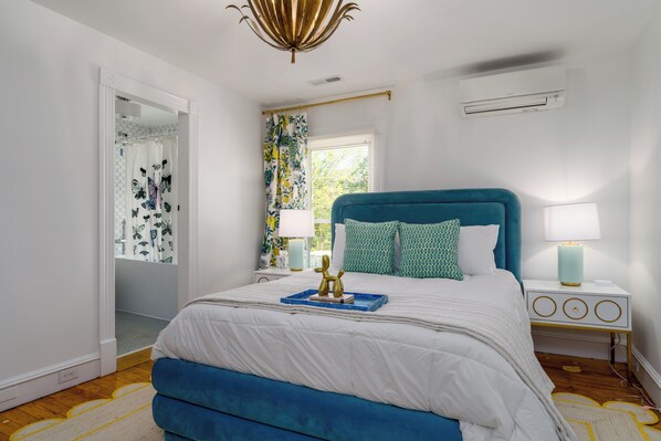 Suite 6: Queen bed, 50" Smart TV, porcelain tile bath with soaking tub, and table with 2 chairs for meals or WFH.
