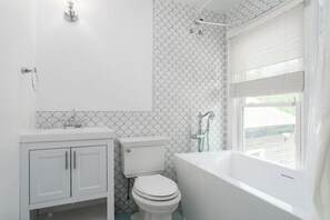 Suite 6: Queen bed, 50" Smart TV, porcelain tile bath with soaking tub, and table with 2 chairs for meals or WFH.