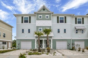 Charming exterior of the Lost Key townhouse with private beach club access and serene surroundings