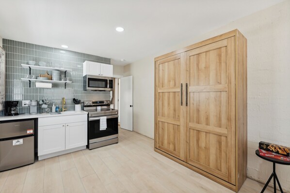 This cozy and stylish studio apartment featuring a space-saving Murphy bed will provide you with comfort and functionality for your stay.