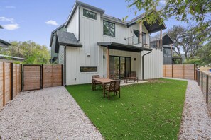 Enjoy a peaceful backyard setting with a lush tree enhancing the tranquil environment.