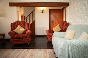 Tow armchairs and sofa. Stairs leading to the first floor