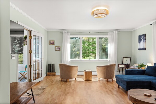 Yoga mats (left corner of living room); Bluetooth record player (right corner)