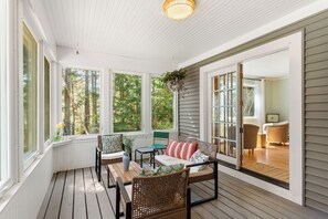 Deck with lounge chairs, screen windows that open, and now with string lights