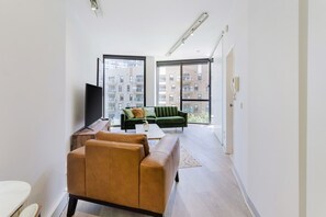 Bright and modern apartment with stylish furniture and large windows overlooking the city.