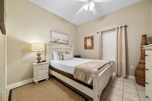 Guest bedroom: Queen bed with natural beach tones are a designer fit.