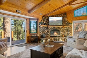 Gather around the crackling fireplace, snuggle up on the plush sofa, and lose yourself in a good book or a captivating movie in the living room space.
