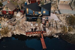 Awaiting your arrival, this newly constructed custom cabin in Boulder Bay stands out as a unique sanctuary, nestled right on the water's edge where the shimmering lake meets the deck's base.