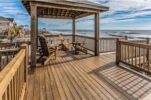 Private gazebo with adirondack chairs, footrests, and tables
