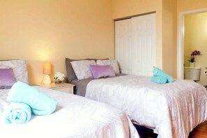 Master Bedroom that includes 2 double sized beds with an attached full bathroom 