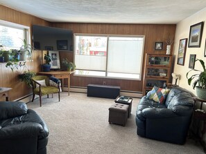 Brightly lit living room space with smart tv