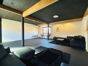 A spacious living room with a large opening. The design exudes a sense of openness.