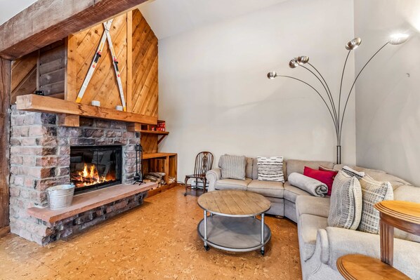 Living Room: Wood-burning fireplace, 65" Smart TV, radiant heat, no A/C 