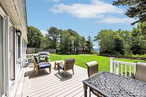 Grill out and unwind on the spacious back deck with a peekaboo view of the ocean just beyond the trees.