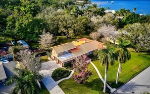 Estately Gardens from above—an exceptional home just steps from the Manatee River, with expansive grounds and a stunning new pool.