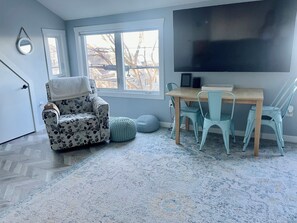Living Room with Smart TV, table & 4 chairs.